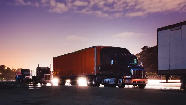 Trucks are parked along a highway.