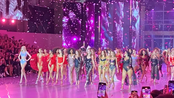 Models in lingerie walk the runway at the end of the Victoria's Secret fashion show as confetti falls.