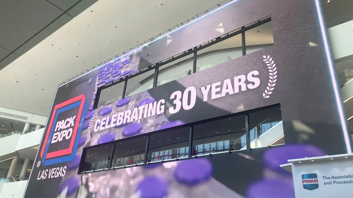 A large screen inside the Las Vegas Convention Center shows the Pack Expo logo and reads "CELEBRATING 30 YEARS"