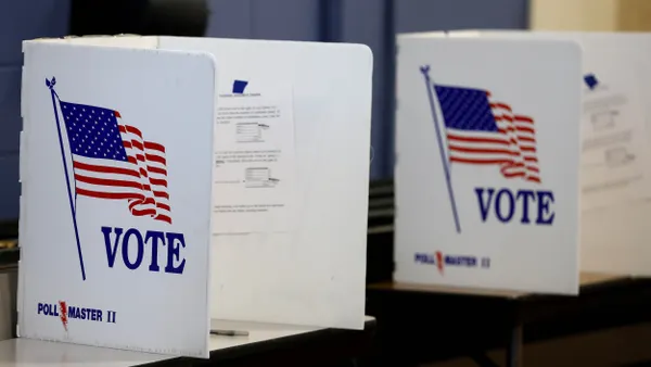 White booths with U.S. flags and the word "Vote"