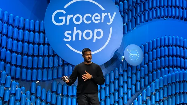 A person speaking on a stage at a conference.
