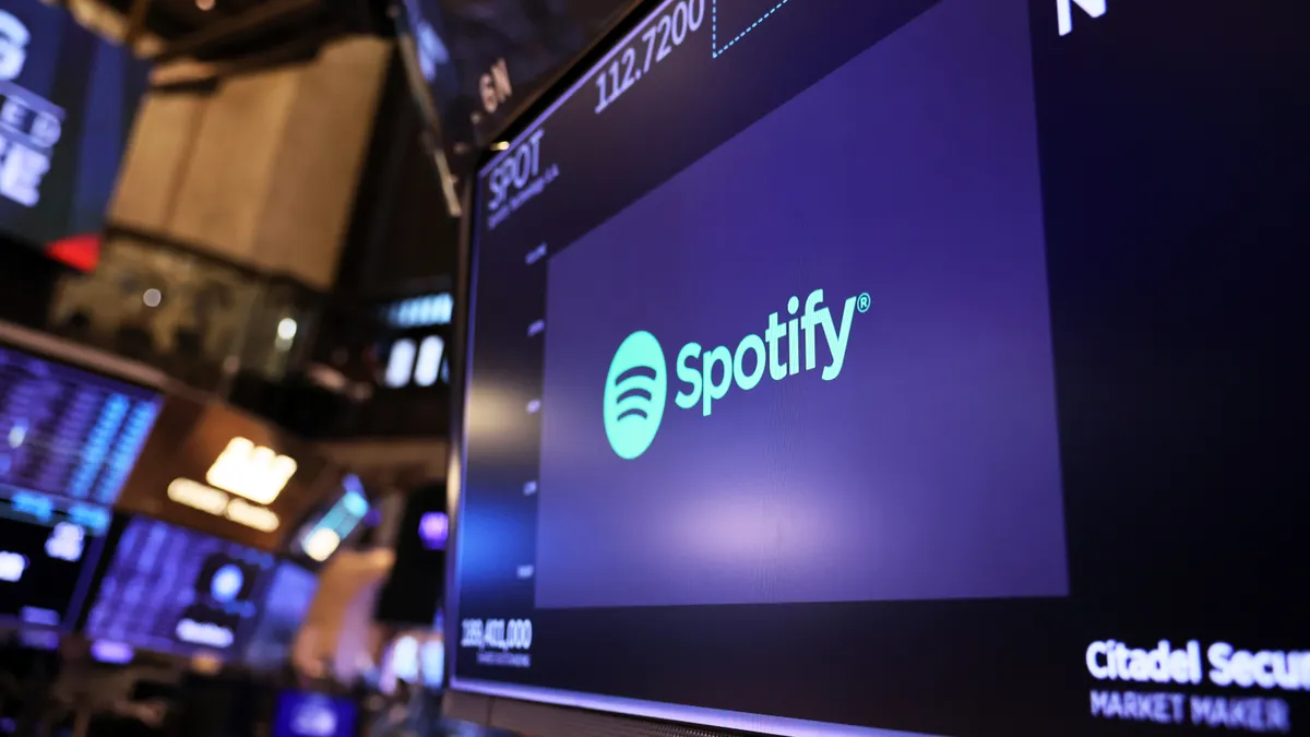 The Spotify company logo is diaplayed as traders work on the floor of the New York Stock Exchange (NYSE) during morning trading on February 01, 2023 in New York City.