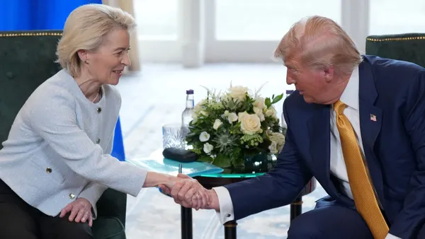 U.S. President Donald Trump and European Commission President Ursula von der Leyen shake hands after concluding trade negotiations on July 27, 2025, in Turnberry, Scotland