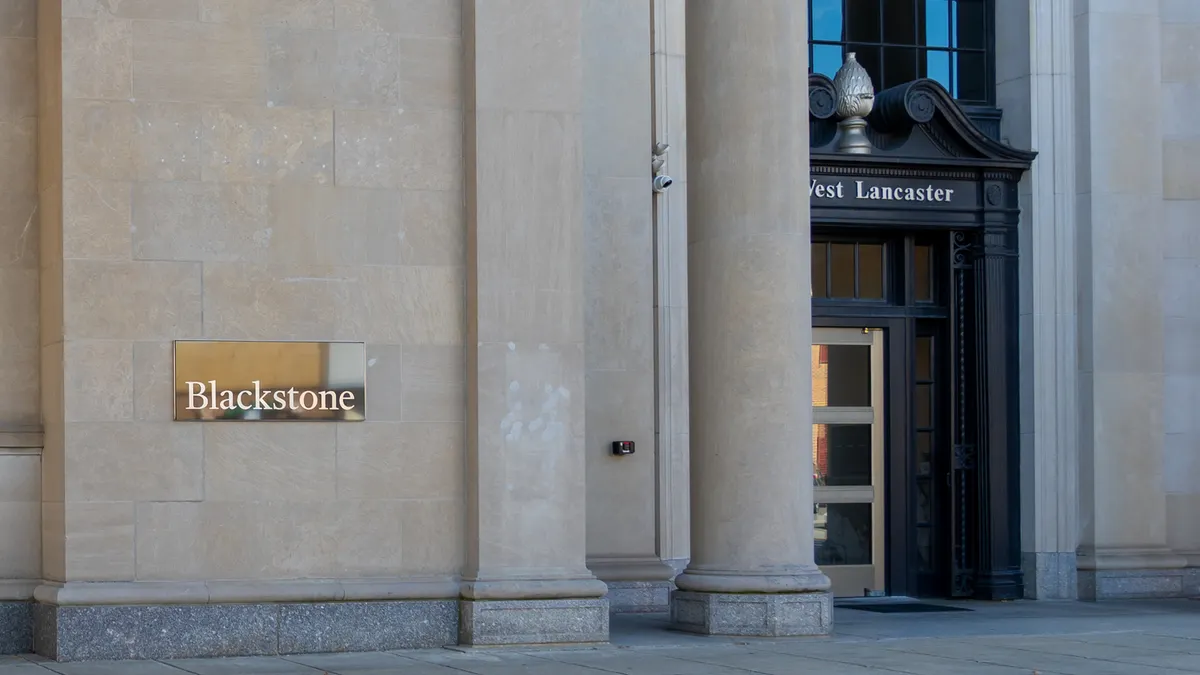 Office building seen with Blackstone logo on gold plaque.