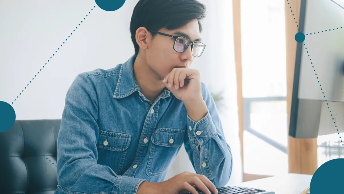 A person focused typing on a keyboard