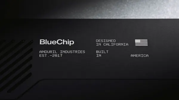 White text that says Blue Chip and Anduril Industries, Est. -2017, Designed in California, Built in America and a U.S. flag on a black laptop.