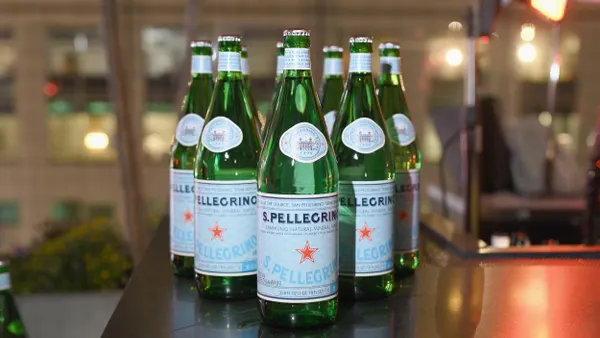 Bottles of S. Pellegrino are lined up on display.