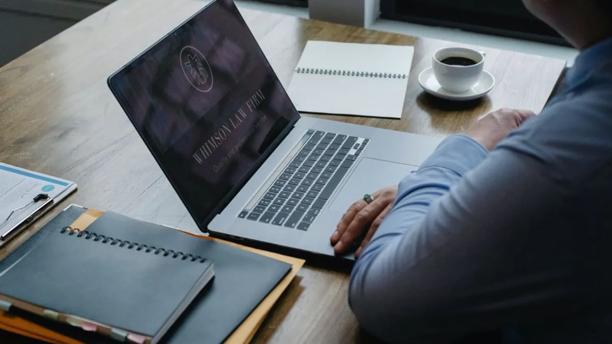 Male entrepreneur working at laptop in workplace