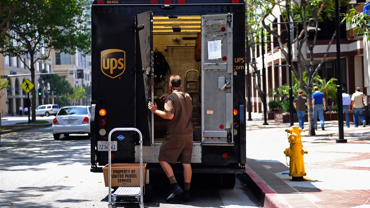 A UPS driver walks back to his truck after making a delivery on July 22, 2010 in Glendale, California.