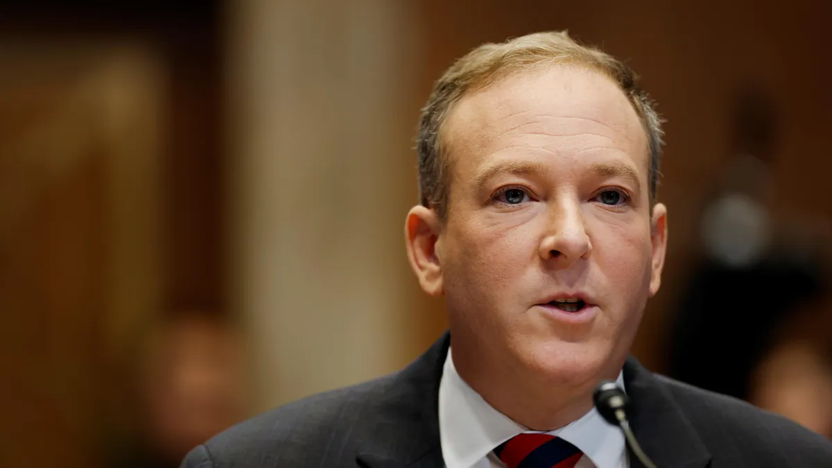 Lee Zeldin sits at a desk