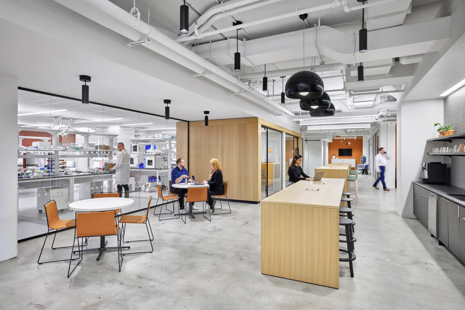 Workers walk through the halls of a modern laboratory