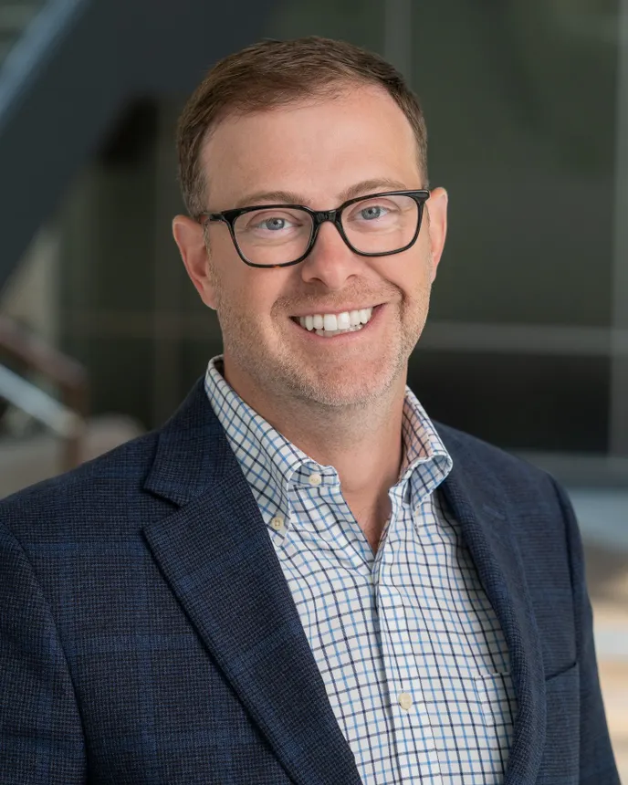 Headshot of a man in professional attire.