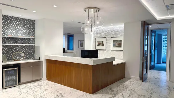 The interior of a crisp, modern-looking office with white accents.