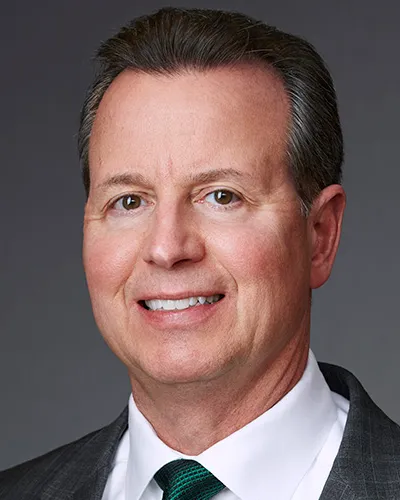 A headshot shows Tutor Perini executive Gary Smalley.