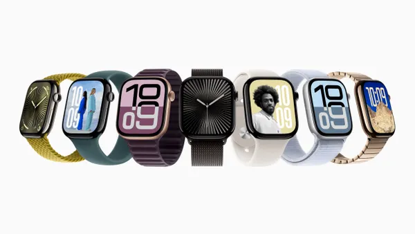 Seven watches lined up side to side with different screens and colors.