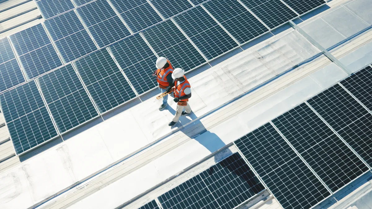 Workers walking on solar panels