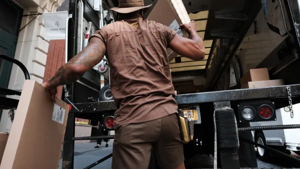 A UPS worker in Manhattan delivers packages on his daily rounds on July 24, 2023 in New York City.