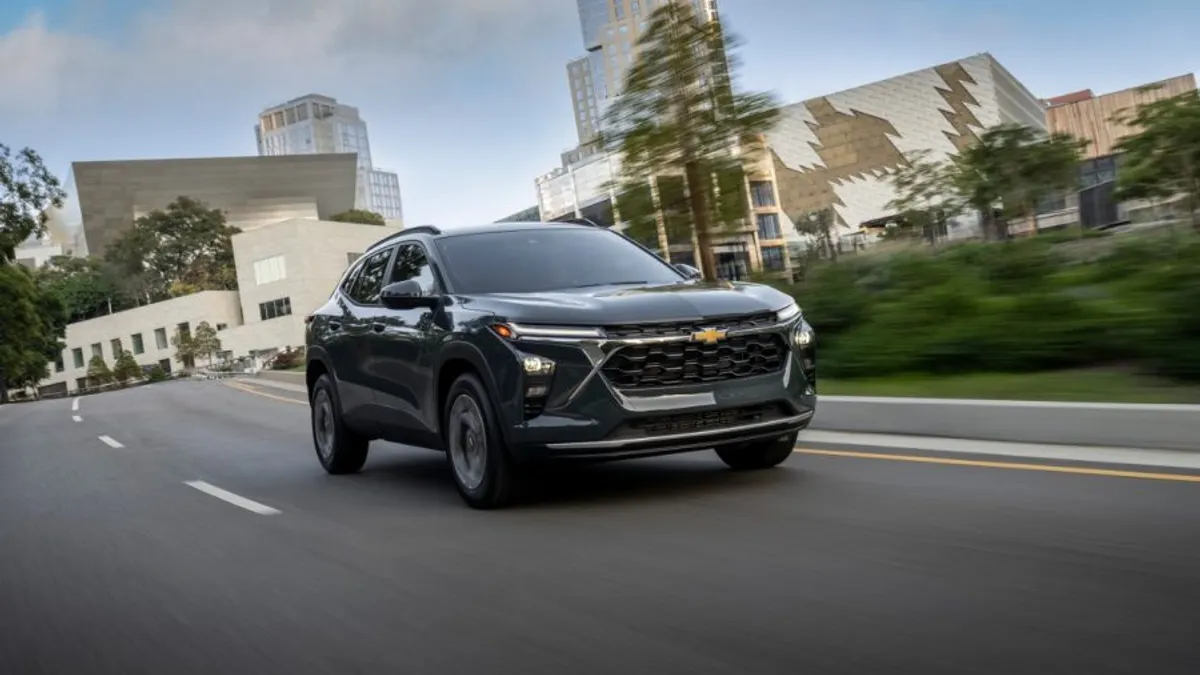 A 2026 Chevrolet Trax LT in Cypress Gray driving on a an urban road.