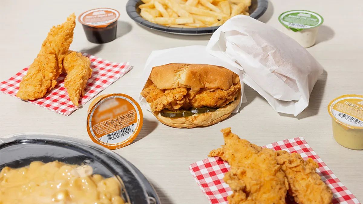 Table of fast food (burger, chicken tenders, fries) and sauces