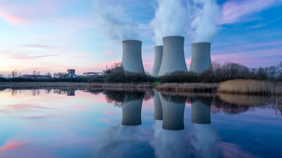 Nuclear power plant after sunset. Dusk landscape with big chimneys.