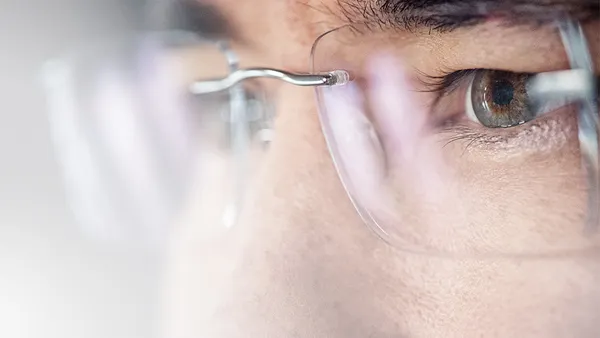 A zoomed in picture to a person's eyes with glasses on