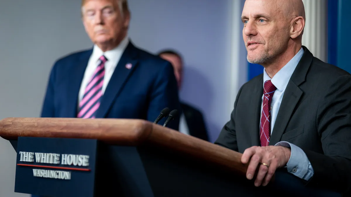 President Trump listens as FDA Commissioner Stephen Hahn delivers remarks at COVID-19 update briefing on April 24, 2020