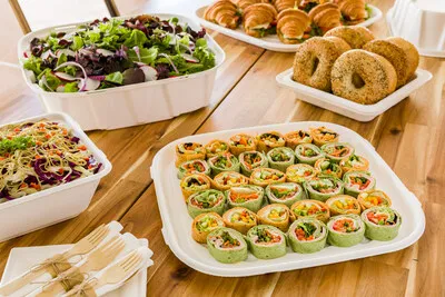 Food in various take-out containers that are made from sugarcane.