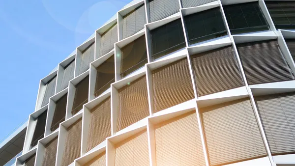 Sunlight shines through a large window of a building, creating a warm and inviting atmosphere inside.