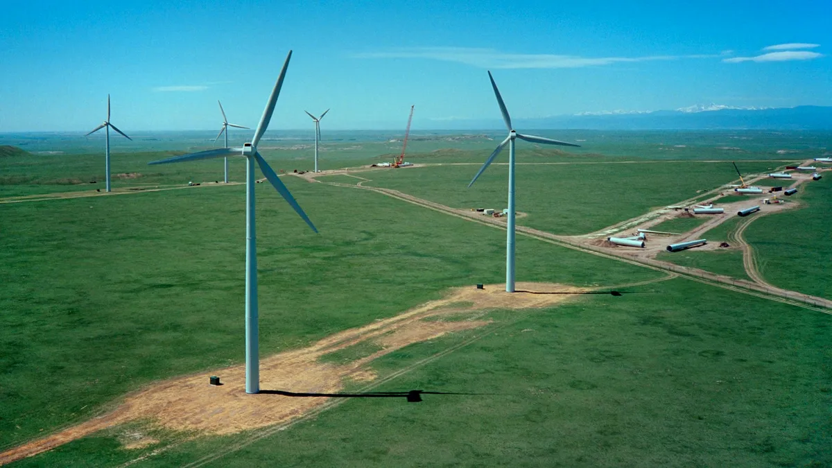 Colorado wind farm construction with Rocky Mountains.