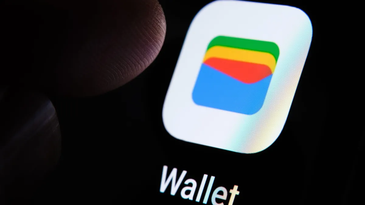 Close-up of a smartphone screen displaying the Google Wallet app interface, with a fingertip hovering above it, indicating user interaction.