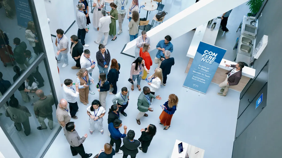 Overhead image of people networking at a professional conference.