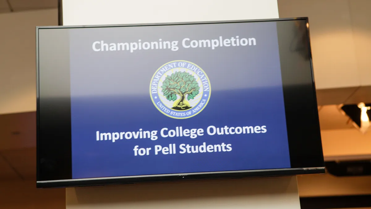 A television monitor shows a U.S. Department of Education logo against a blue background.