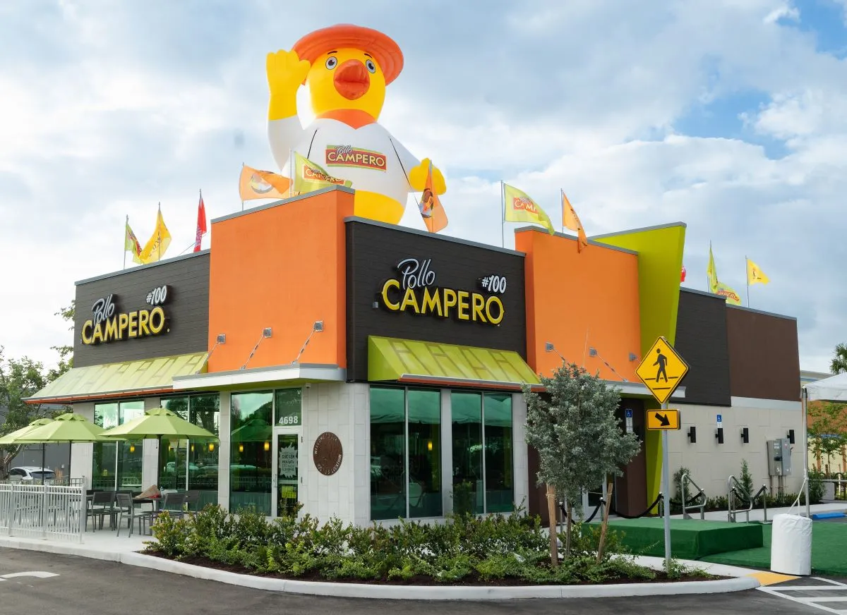 An image of a Pollo Campero with an inflatable chicken on the roof.