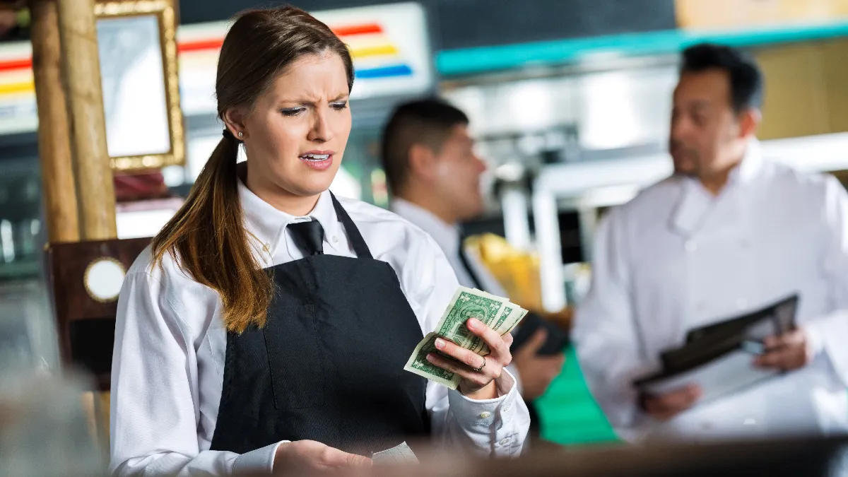 Waitress in Tex-Mex restaurant disappointed in small tip from customer.