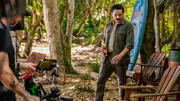 Gabriel Luna holds a bottle of Corona while filming.