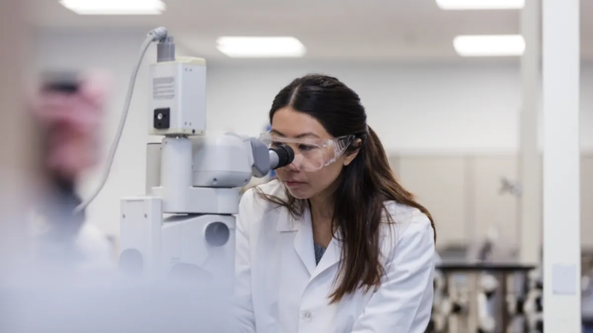 Scientist using a microscope