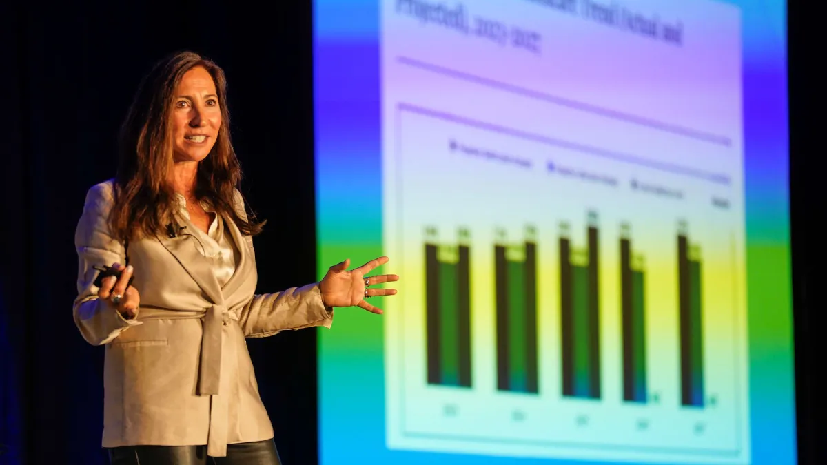 Woman presents in front of charts