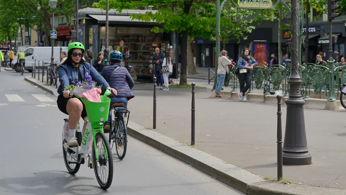 A rider on a bicycle along a Paris street.