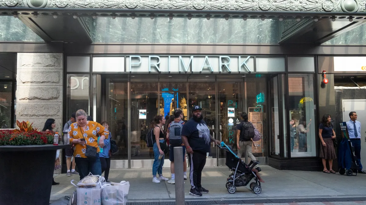 A primark storefront with customers walking past