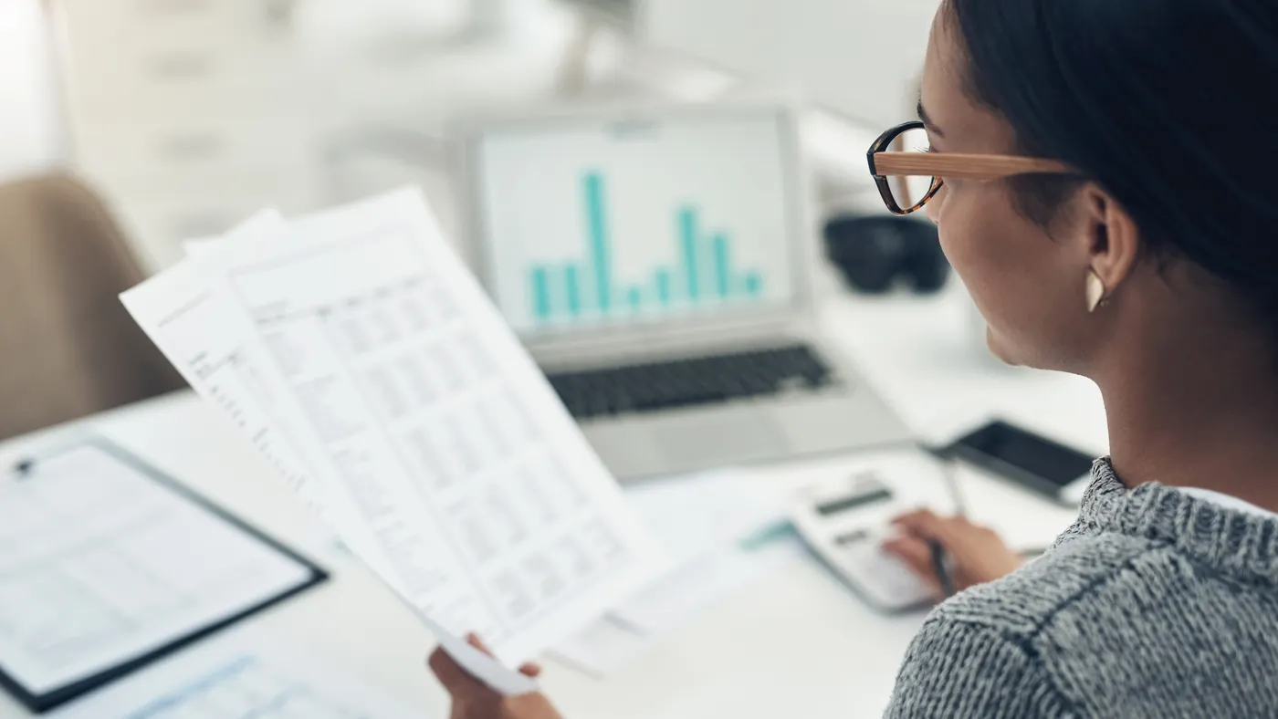 Closeup shot of a person calculating finances in an office