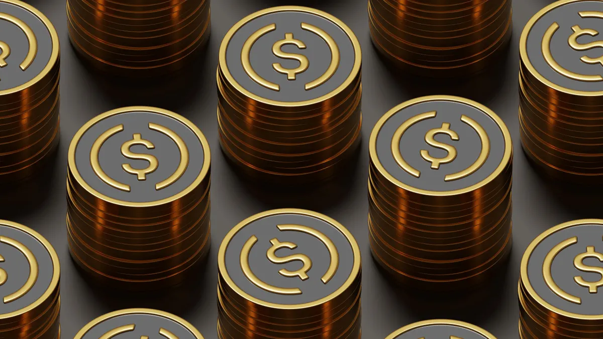Stacks of metal coins with circles and a dollar sign in the middle.