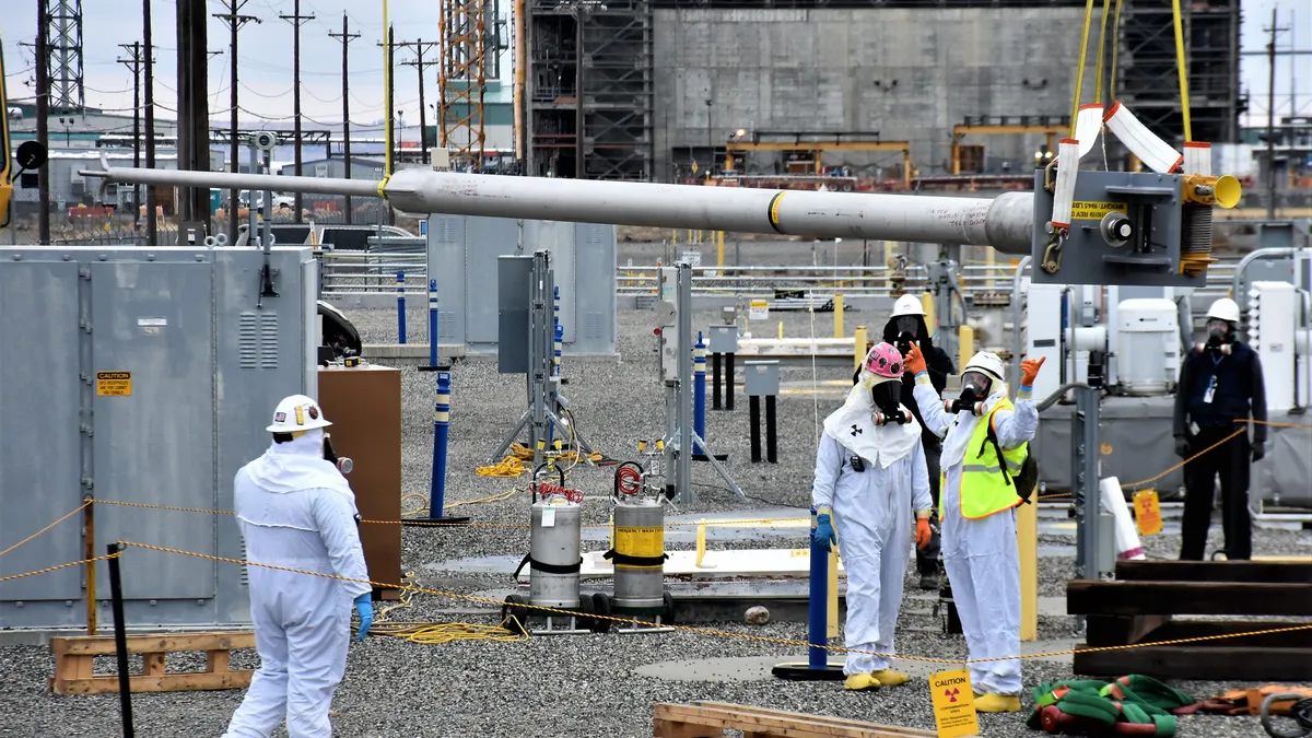 Workers prepare for chemical waste transfers