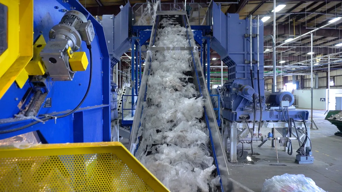 Conveyor belt with plastic film, within warehouse