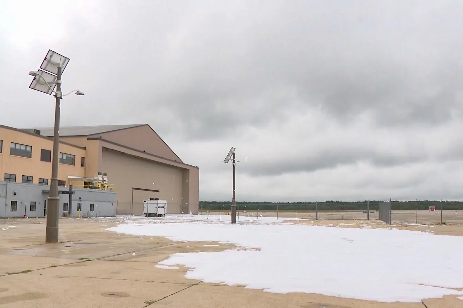 White foam in front of an airport building.