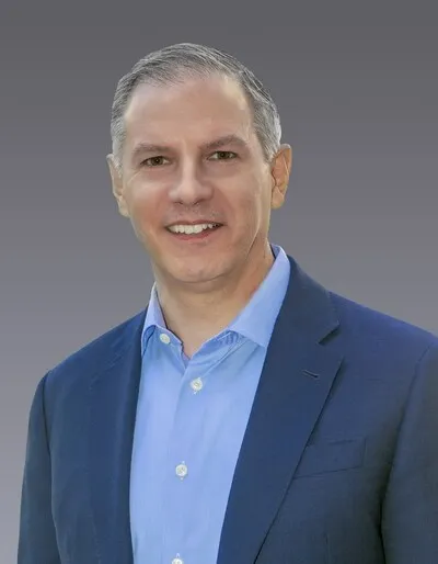 Headshot of Ron Delia, CEO at Amcor