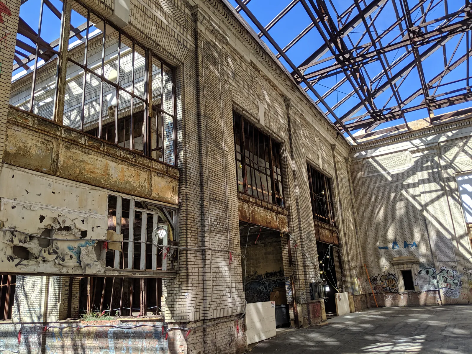 The interior of the Michigan Central Station building prior to the restoration project show blue sky from a roof that is partially missing.