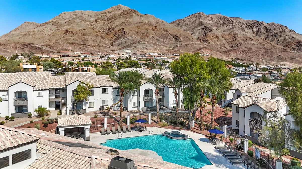 Two-level apartments with mountains in the background.