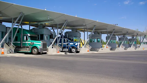 Two semi-trucks at the Canadian border.