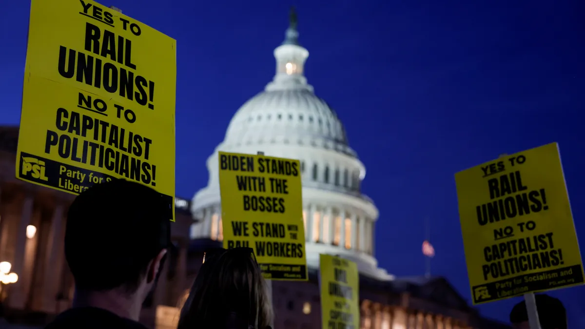 Signs with messages such as "Yes to Rail Unions! No to capitalist politicians!" is seen in front of the U.S. Capitol