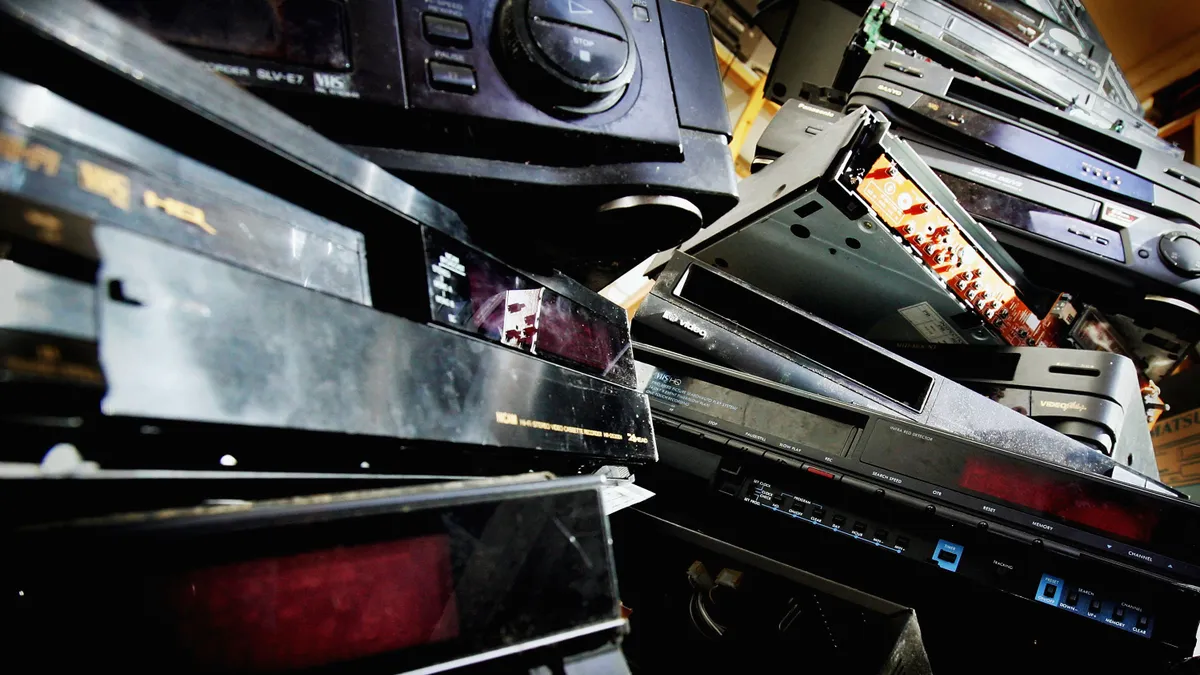 A close-up image of stacks of broken laptops